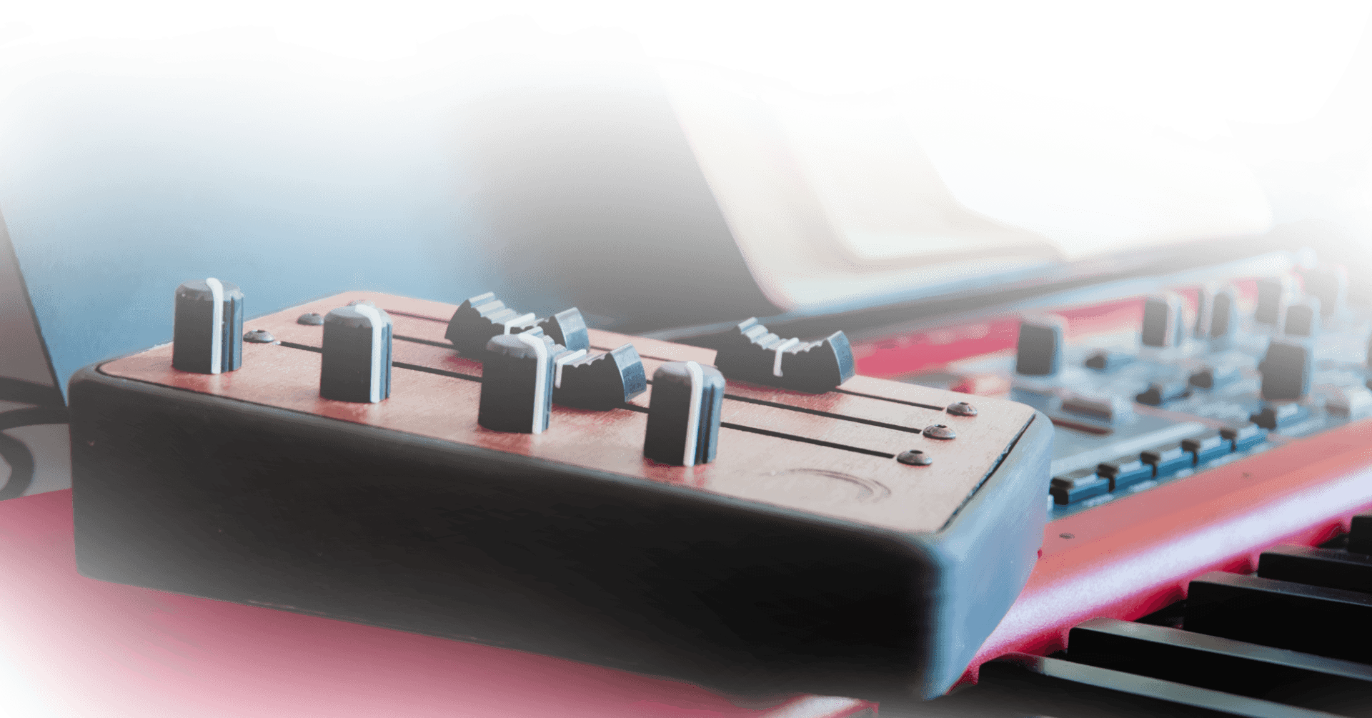 Brise Midi Controller on a piano, with close up on the long faders and knobs
